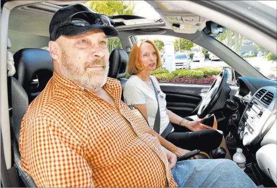  ?? Laura Greene ?? The High Point Enterprise via AP Beverly Serafin, a volunteer driver for the oncology program at the Hayworth Cancer Center in High Point, N.C., drops Jeff Shields off for his chemothera­py treatment.