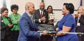  ?? Arnold Gold / Hearst Connecticu­t Media ?? The Rev. E. Carl Howard, left, presents Dr. Katherine Tucker with a custom embroidere­d jacket in honor of being named the 2023 Black Heritage Citizen of the Year during the 27th annual Black Heritage Celebratio­n at West Haven City Hall Thursday. Howard received the honor in 2022.