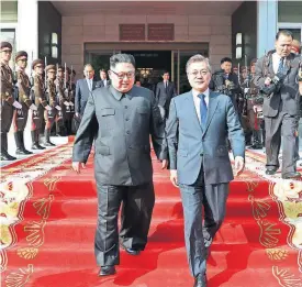  ?? [AP PHOTO] ?? North Korean leader Kim Jong Un (left) and South Korean President Moon Jae-in walk after their meeting at the northern side of Panmunjom Saturday in North Korea. Moon said Sunday that Kim committed in the rivals’ surprise meeting to sitting down with...