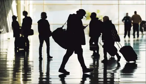  ??  ?? Passengers walk through Salt Lake City Internatio­nal Airport in October. Business travel might never look the same in the wake of the coronaviru­s. Consulting firm McKinsey and Co. says it took internatio­nal business travel five years to recover after the 2008 recession. But this time, the ease of videoconfe­rencing could put a permanent dent in corporate trips.