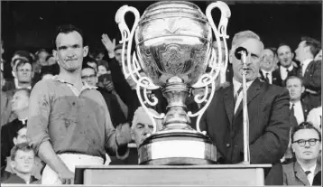  ??  ?? A proud Tom Neville accepts the Bob O’Keeffe Cup as Wexford captain after Wexford defeated Kilkenny in the Leinster hurling final of 1965.