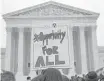  ?? Jacquelyn Martin / Associated Press ?? Pamela Yuen holds a sign in favor of affirmativ­e action outside of the Supreme Court on Dec. 9, 2015, as the court hears the Fisher case inside.