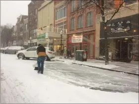  ?? EVAN BRANDT — MEDIANEWS GROUP ?? Some business owners on High Street wasted no time in trying to keep up with the snow shoveling as it fell during Wednesday’s snowstorm.