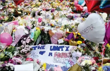  ?? BEN STANSALL/AFP ?? A carpet of flowers and messages lie at St Ann’s Square in Manchester, northwest England on May 24, placed in tribute to the victims of the May 22 terror attack at the Manchester Arena.