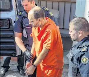  ?? CP PHOTO ?? Matthew Vincent Raymond, charged with four counts of first-degree murder, is taken from provincial court in Fredericto­n on Monday. Two city police officers were among four people who died in a shooting in a residentia­l area on the city’s north side.