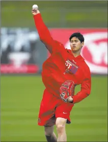  ?? Ben Margot ?? The Associated Press Former Japanese League pitching/hitting star Shohei Ohtani plays long toss during a spring training workout Tuesday in Tempe, Ariz.