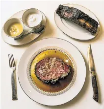  ??  ?? Prime rib, carved tableside and served with a smoked, slow-cooked bone, is the menu’s superstar dish.