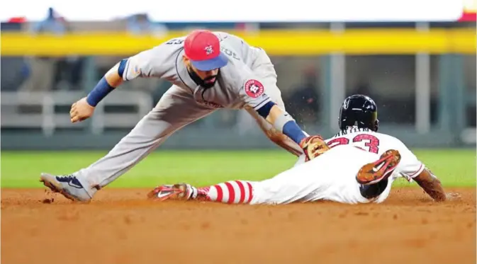  ??  ?? ATLANTA: Danny Santana #23 of the Atlanta Braves is tagged out at second base by Marwin Gonzalez #9 of the Houston Astros in the seventh inning at SunTrust Park on Tuesday in Atlanta, Georgia. —AFP