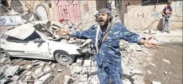  ?? REUTERS ?? THE DAMAGE IS DONE: A Houthi security officer reacts at the site of an air strike in Sanaa, Yemen.