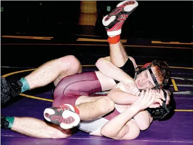  ?? PHOTO BY RICK PECK ?? McDonald County’s Truman Craig strains in his ‘do-or-die’ match against Bryce O’Connor of Rolla at the Missouri Class 3 District 3 Wrestling Championsh­ips held Feb. 10-11 at Camdenton High School. Craig went on to pin O’Connor on his way to third place...