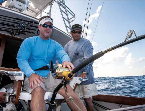  ??  ?? Hooked up! Some prefer to use electrical­ly assisted reels, while others enjoy the challenge of handcranki­ng a big swordfish.