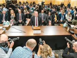  ?? SUSAN WALSH/AP ?? Photograph­ers jostle for position as witness Chris Stirewalt, a former Fox News political editor who was fired by the network, gets ready to testify Monday during a hearing before the House Select Committee to investigat­e the Jan. 6, 2021, Capitol breach.