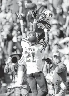  ?? Todd Kirkland / Associated Press ?? Auburn wide receiver Seth Williams leaps above Texas A&amp;M defensive back Charles Oliver for a touchdown reception during the first half Saturday at Auburn, Ala.