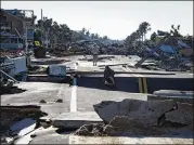  ?? JABIN BOTSFORD / WASHINGTON POST ?? Residents make their way across a washed-out road in Mexico Beach, Fla. The storm surge there reached 15.55 feet.