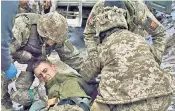  ?? ?? Army medics give first aid to a wounded soldier near Kreminna in the Luhansk region of Ukraine