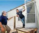  ?? [PHOTO BY JIM BECKEL. THE OKLAHOMAN] ?? Sam Porter is shown talking to Darryn Cook on the porch of a refurbishe­d mobile home in Bethel Acres that Cook received through Southern Baptist Disaster Relief donations.