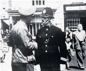  ??  ?? Above: Jenny Seagrove as Louisa Gould and Julian Kostov as Bill in
Gould, below left, and a German soldier talking to a British policeman on Jersey in 1940, left