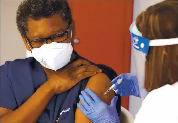  ?? PHOTOS BY SHMUEL THALER — SANTA CRUZ SENTINEL ?? Dominican Hospital nurse Toni Luckett on Wednesday becomes the first person in Santa Cruz County to be vaccinated against COVID-19. Dominican Hospital and Watsonvill­e Community Hospital started vaccinated employees on Wednesday with Pfizer-BioNTech’s vaccine, of which 1,950 doses arrived in the county on Tuesday.