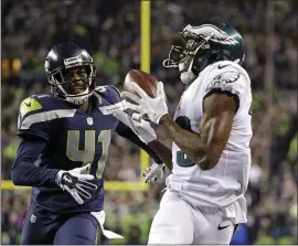  ?? TED S. WARREN — THE ASSOCIATED PRESS ?? Nelson Agholor, a free agent shown catching a touchdown pass against the Seahawks while he played for the Eagles, joins the lineup of receiver hopefuls for the Raiders.