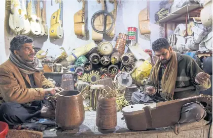 ??  ?? LEFT Workers make traditiona­l rabab stringed instrument­s in a workplace on the outskirts of Peshawar.