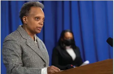  ?? (AP/Chicago Tribune/Brian Cassella) ?? Chicago Mayor Lori Lightfoot (at lectern) and Chicago Public Schools CEO Janice Jackson announce Sunday at City Hall that a tentative agreement has been reached with the Chicago Teachers Union to reopen schools.