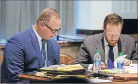  ?? [CHRIS LANDSBERGE­R/ THE OKLAHOMAN] ?? Oklahoma City police Sgt. Keith Patrick Sweeney, left, who is charged with second-degree murder in the 2017 death of an unarmed suicidal man, sits in his trial in the courtroom of District Judge Natalie Mai at the Oklahoma County Courthouse on Thursday. Evan King, at right, is a member of Sweeney's legal team.