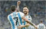  ?? RICARDO MAZALAN/AP ?? Argentina’s Lionel Messi, right, celebrates with Rodrigo De Paul after Nahuel Molina scored during a World Cup quarterfin­al between the Netherland­s and Argentina at Lusail Stadium in Lusail, Qatar, on Dec. 9.