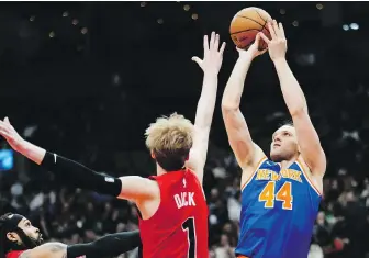  ?? FRANK GUNN, THE CANADIAN PRESS ?? Knicks forward Bojan Bogdanovic shoots over Raptors guard Gradey Dick during second-half action in Toronto on Wednesday.