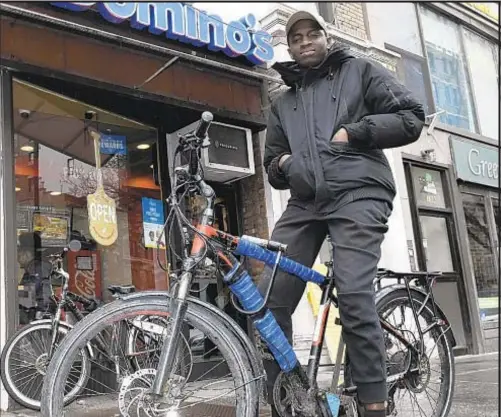  ?? BARRY WILLIAMS/FOR NEW YORK DAILY NEWS ?? Alou Bathily saw police chasing a man on the Upper West Side Friday and rode his Domino’s pizza delivery bike into the fray. He caught up to the suspect, jumped off and held the man until police slapped the cuffs on him.