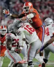  ?? RICK SCUTERI — THE ASSOCIATED PRESS FILE ?? This Dec. 31, 2016photo shows Clemson defensive end Clelin Ferrell (99) pressuring Ohio State quarterbac­k J.T. Barrett (16) after Barrett threw a pass, during the second half of the Fiesta Bowl NCAA college football playoff semifinal, in Glendale,...