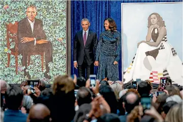  ?? AP ?? Former US president Barack Obama and former first lady Michelle Obama stand on stage together as their official portraits are unveiled at a ceremony at the Smithsonia­n’s National Portrait Gallery.
