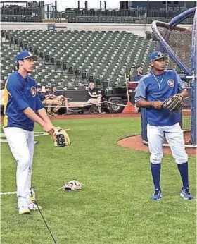  ?? TODD ROSIAK ?? Brewers second-round pick Joe Gray (right) works out with Christian Yelich before Friday night’s game at Miller Park.