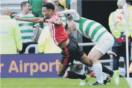  ??  ?? Sunderland left-back Brendan Galloway goes down under Callum McGregor’s challenge for Celtic on Saturday. Picture by Frank Reid.