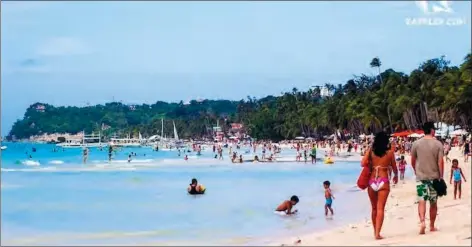  ?? (Angie de Silva/Rappler file photo) ?? Tourists trek White Beach in Boracay Island.