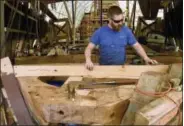  ?? SEAN D. ELLIOT — THE DAY VIA AP ?? In this photo, shipwright Chris Sanders checks the camber as he fairs the foredeck substructu­re of the Mayflower II at Mystic Seaport’s H.B. duPont Preservati­on Shipyard in Mystic, Conn. Restoratio­n of the ship, a replica of the vessel that brought...