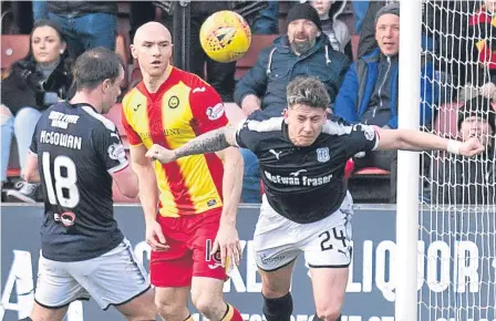  ??  ?? Josh Meekings (right) was a rock at the back for Dundee in their 2-1 victory at Partick Thistle last weekend.