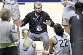  ?? AP file photo ?? UConn coach Geno Auriemma talks to his team during the Big East tournament semifinals on March 7. The Huskies will be without Auriemma for the opening weekend of the NCAA Tournament after the coach tested positive for COVID-19.