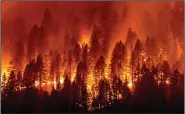  ?? (AP/Noah Berger) ?? The Dixie Fire burns down a hillside Friday toward Diamond Mountain Road near Taylorsvil­le in Plumas County, Calif. Video at arkansason­line.com/815dixie/.