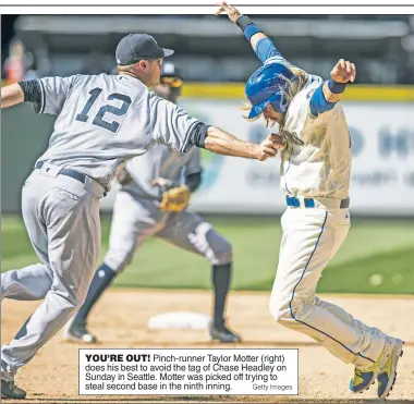  ?? Getty Images ?? YOU’RE OUT! Pinch-runner Taylor Motter (right) does his best to avoid the tag of Chase Headley on Sunday in Seattle. Motter was picked off trying to steal second base in the ninth inning.