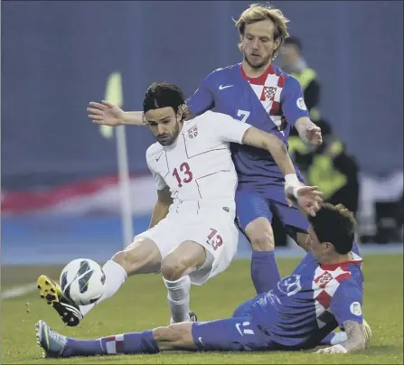  ?? Picture: Reuters ?? Serbia’s Ivan radavanovi­c, left, is challenged by Ivan rakitic and Mario Manzukic of croatia in Zagreb last night