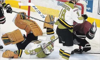  ?? CLIFFORD SKARSTEDT EXAMINER ?? Peterborou­gh Petes forwardNik­ita Korostelev leaps to avoid North Bay Battalion goalie Christian Propp during first period OHL action on Thursday. Korostelev could be ECHL bound after the season ends.