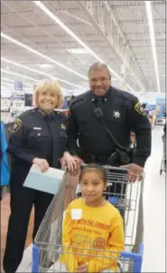  ?? FRAN MAYE - DIGITAL FIRST MEDIA ?? Haley Jauarz Barrera, a second-grader at the Chester County Family Academy, enjoys Christmas shopping with Chester County Sheriff Carolyn “Bunny” Welsh at the Walmart in East Marlboroug­h.