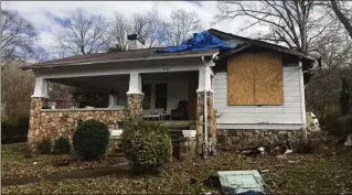  ?? COURTESY OF DEBORAH PRZYBYSZ ?? A previous resident of the Przybyszes’ house in Chattanoog­a, Tennessee, seen before they renovated it, set a fire that burned a hole in the roof.