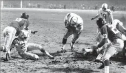  ?? ASSOCIATED PRESS FILE PHOTO ?? Baltimore Colts fullback Alan Ameche advances through a big opening to score the winning touchdown in overtime against the New York Giants on Dec. 28, 1958.