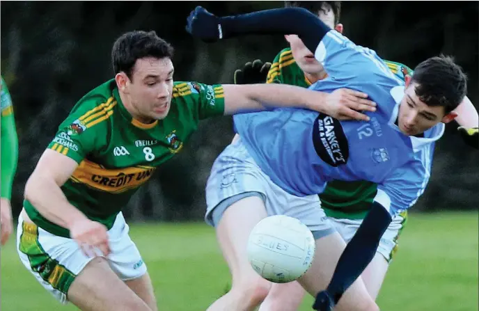  ??  ?? Cooley’s Peter Thornton and Blues’ Ciaran Downey tussle for possession during their Division 1 clash last weekend. Picture: Kieran Carr