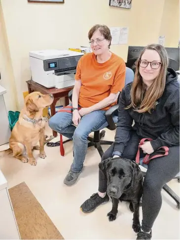  ?? Emily M. Olson/Hearst Connecticu­t Media ?? Winsted's Educated Canines Assisting with Disabiliti­es held a graduation ceremony for six veterans this week, including Zvia Ratz and her dog Happy, left, and Kristin Hernandez and her dog Tee Time.