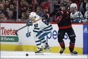  ?? KARL B DEBLAKER — THE ASSOCIATED PRESS ?? The Carolina Hurricanes’ Sebastian Aho (20) tangles with the San Jose Sharks’ Kevin Labanc (62) during the second period in Raleigh, N.C., on Friday.