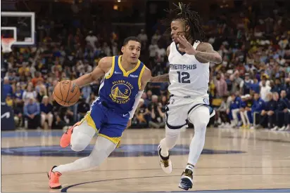  ?? PHOTOS BY BRANDON DILL — THE ASSOCIATED PRESS ?? Golden State Warriors guard Jordan Poole (3) drives against Memphis Grizzlies guard Ja Morant (12) in the second half during Game 1of a second-round playoff series Sunday in Memphis, Tenn.