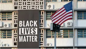  ?? — AP ?? Bold statement: The Black Lives Matter banner hanging outside the US Embassy in Seoul before it was removed.