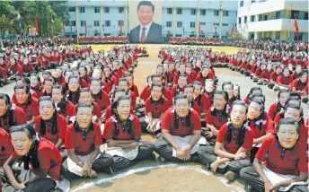  ?? —DC ?? Over 2,000 students wearing Chinese president’s mask rehearse for his welcome event at Everwin payground in Kolathur.They will be making a huge formation of his name in Mandarin. Over 1.5 tonne of flowers will be used to fill the letters and 1,500 students carrying Indian and Chinese flags will border around the formation.